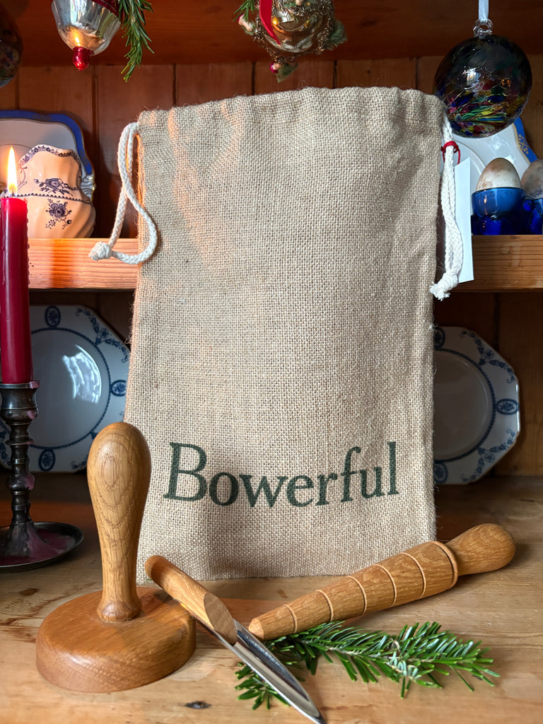 Bowerful bag on a wooden surface with propagator tools 