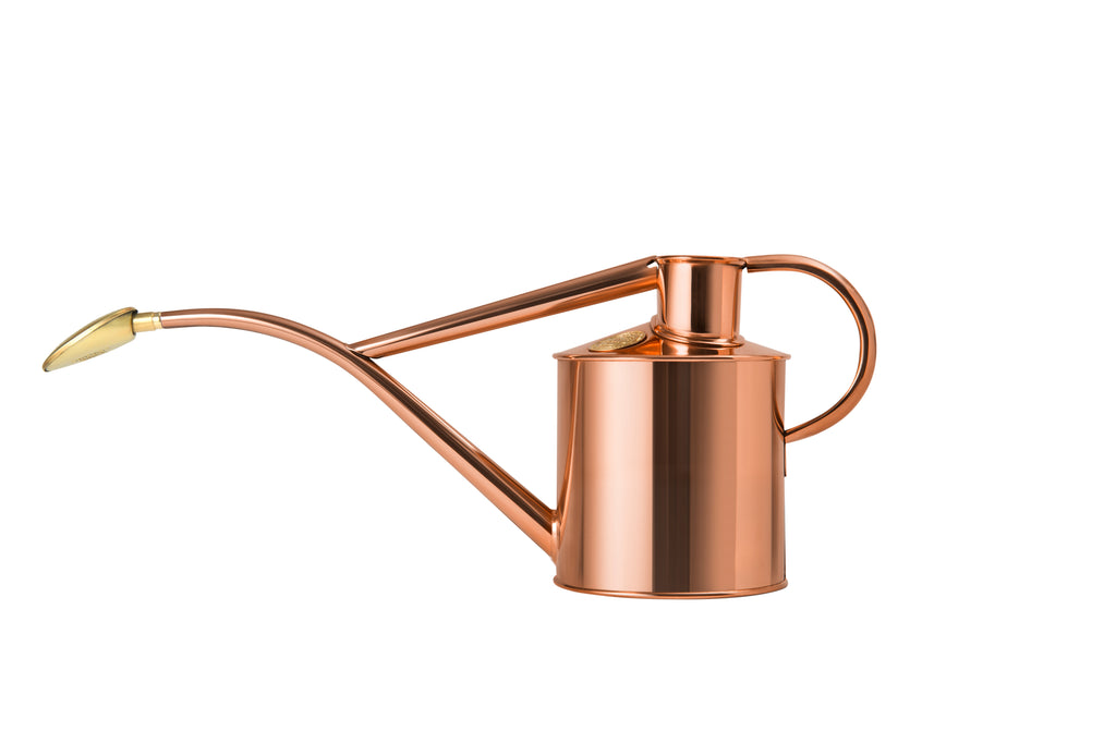 Copper watering can on a white background