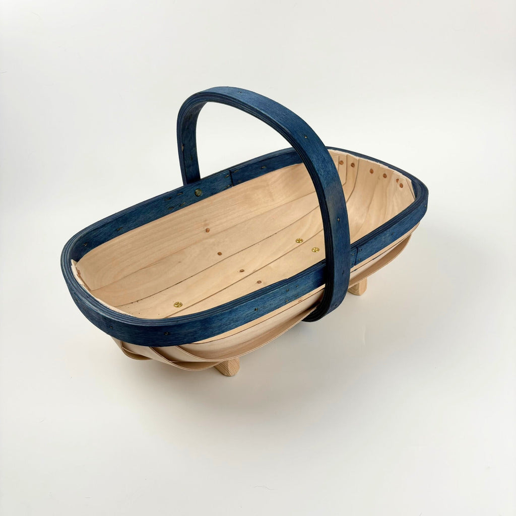 Wooden trug with blue handle on a white background